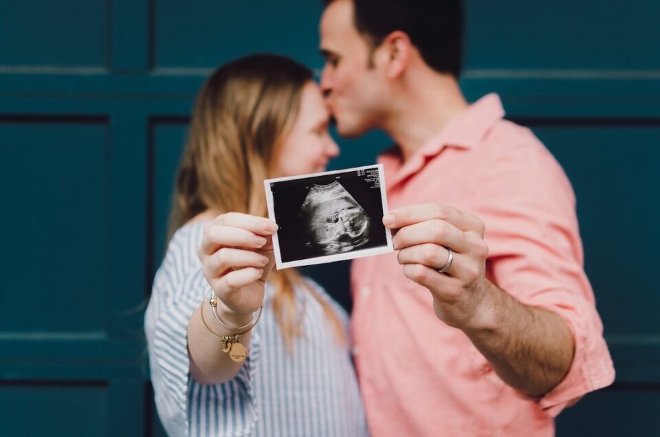 Couple holding a ultrasound photo.